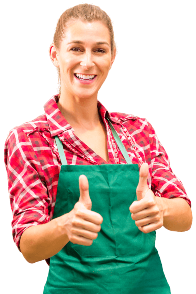 une jardinière très heureuse et contente portant une chemise à carreaux rouge et un tablier vert avec les deux pouces levés signifiant que tout va bien